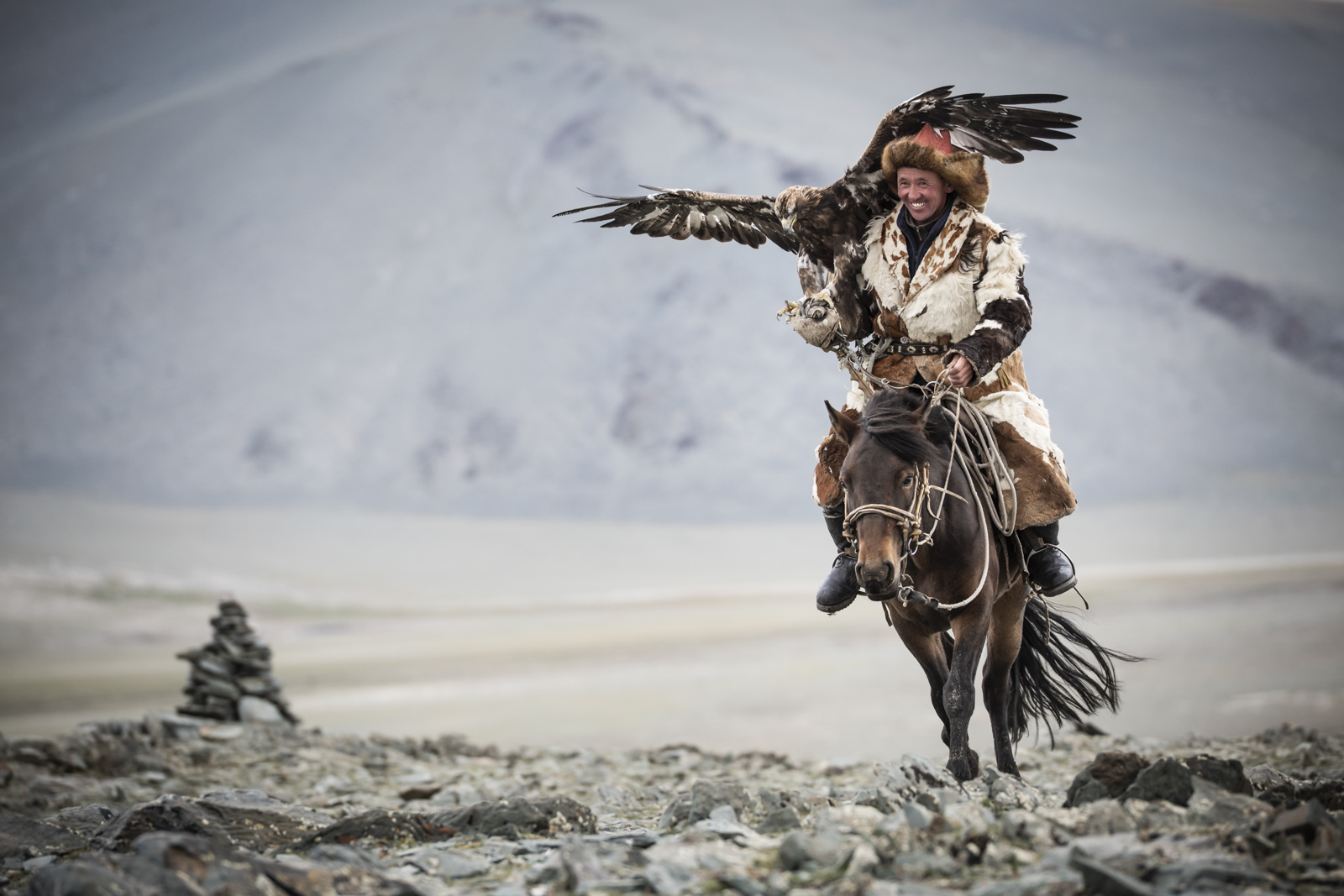 Rider crossing open steppe in Mongolia